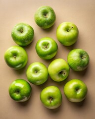 Arranging green apples on a beige background clean flat lay photography food aesthetic minimalistic environment top-down viewpoint for freshness and vibrancy