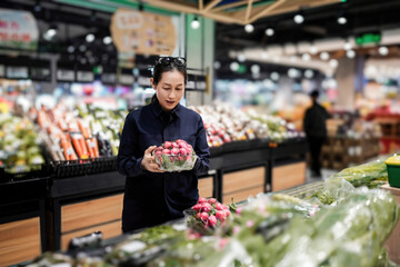 Woman Shopping for Red Onions in a Supermarket
