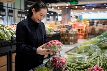 Woman Examining Fresh Red Onions in Grocery Store