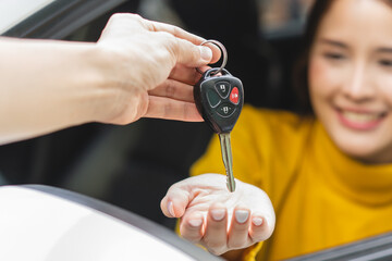 transportation rental automotive business concept. Close up hands of rental auto agent giving car...
