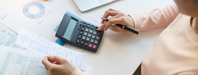 Deduction planning, debt asian young woman  hand using calculator to calculating money balance from...