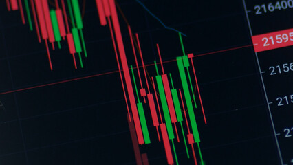 Market Decline: A stark visual representation of market trends, the image captures the volatile nature of financial data, highlighting a downturn with ominous red candlestick charts.