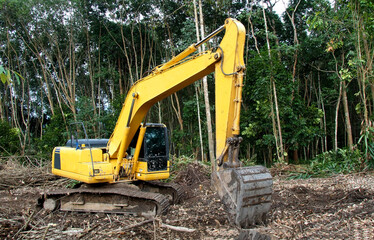 Excavator in Action: A powerful yellow excavator stands poised in a construction site, ready to...