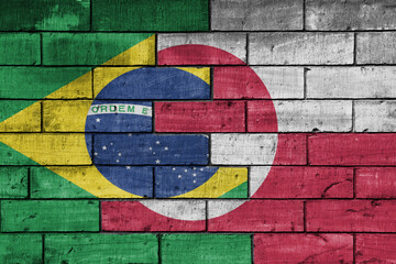 colourful painted big national flag of greenland and flag of brazil on a massive old brick wall background. concept