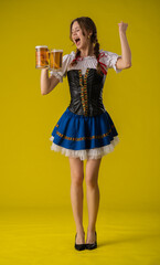 Young Woman Celebrating with Two Glasses of Beer in Traditional Dress