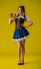 Young Woman in Traditional Costume Holding Beer Mugs