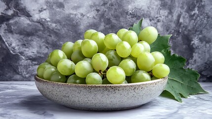 Fresh Green Grapes Still Life in a Ceramic Bowl with Grape Leaves and Marble Background