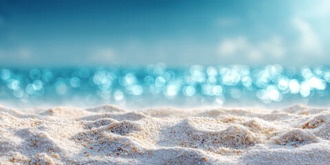 Minimalistic beach background featuring white sand in sharp focus with a blurred turquoise ocean and sky in the distance. The soft bokeh effect creates a dreamy, calm atmosphere ideal for summer theme