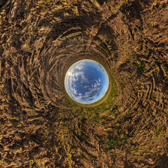 blue hole sphere or globe little planet inside grass or sand or dry ground frame background with...