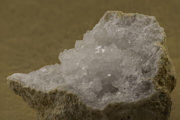 Close-up image of a white crystalline formation within a rock cavity, possibly quartz or calcite. Suitable for geological, scientific, natural history, or earth science-related stock imagery content