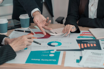 Business people discussing charts and graphs showing results of successful teamwork. Close-up of...