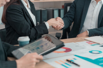 Close-up of business people shaking hands. Concept of unity and teamwork. Meeting about contract....