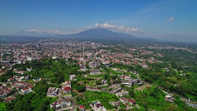 drone view of gombel hill area in semarang with beautiful mount ungaran background. telecomunication tower in semarang city