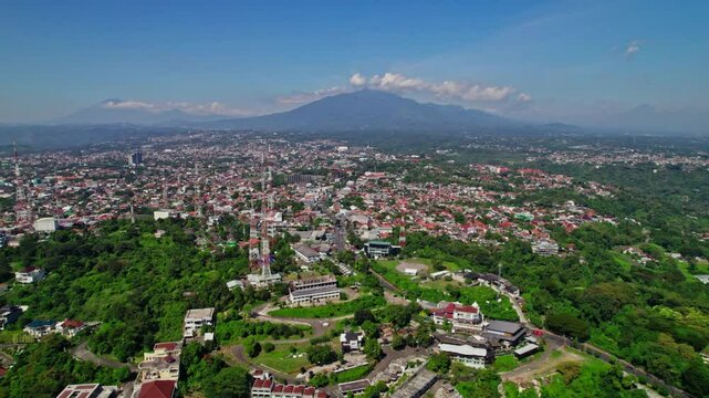 drone view of gombel hill area in semarang with beautiful mount ungaran background. telecomunication tower in semarang city