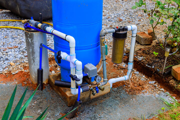 Artesian water well system installed outdoors ensuring clean water supply for gardening home use.