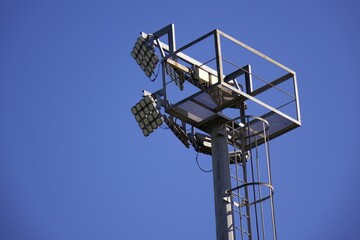 stadium lights against blue sky