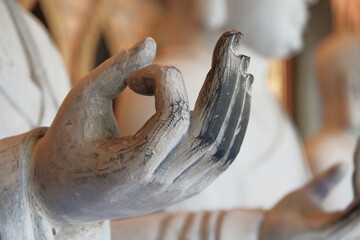 Intricate hand gesture of a statue representing serenity in northern Vietnam's historic temple