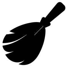 Black silhouette of a witch's broom resting against a white background