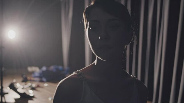 Petite ballet dancer standing backstage, silently preparing for pivotal performance, embodying deep concentration and nervous anticipation before stepping into theatrical spotlight