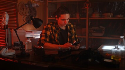 Young Photographer Developing Photos in Darkroom