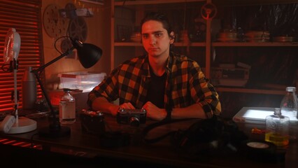 Young Man in Retro Studio with Film Equipment Present