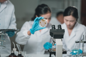 Medical research team conducting scientific experiments in a pharmaceutical laboratory, analyzing...