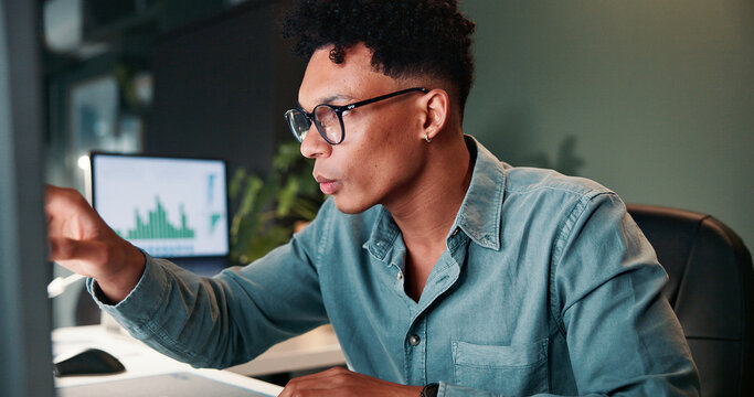 Man, reading and computer for trading in office of statistics review, finance charts and stock market graph. Person, pointing and information for exchange, financial increase and investment pattern