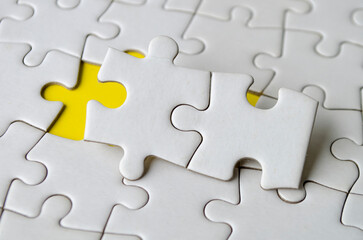 Fototapeta premium Top view of jigsaw puzzle pieces removed from other jigsaw.