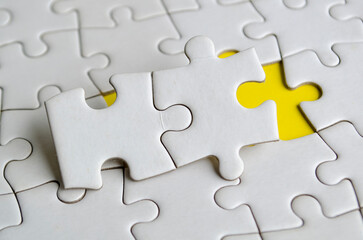 Fototapeta premium Jigsaw puzzle pieces removed from other jigsaw. Customizable space on jigsaw for text or ideas. Copy space concept