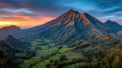 Fototapeta premium Stunning mountain with vibrant sunset in background casting warm hues over tranquil landscape and rolling hills