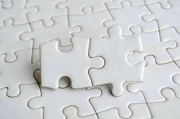 Close up of jigsaw puzzle pieces with customizable space on jigsaw for text or ideas