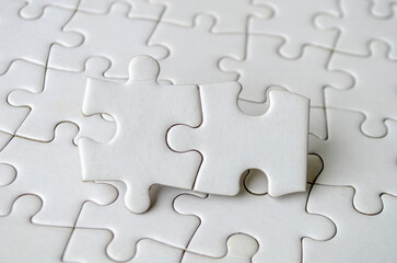 Close up of jigsaw puzzle pieces with customizable space on jigsaw for text or ideas.