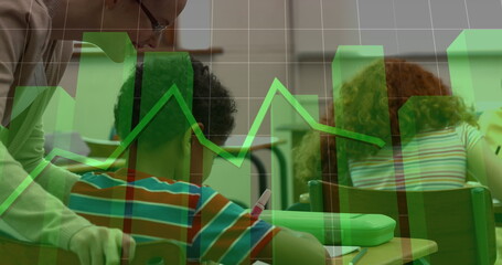 Assisting teacher guiding boy writing on worksheets in classroom, green graph overlay