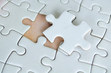 Symbol of partnership and unity shown through connected puzzle pieces. Partnering concept