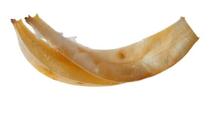 Close up shot of a curved piece of fruit with a shiny surface against a transparent background in studio light