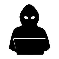 Silhouette of a hooded figure using a laptop with unknown intentions