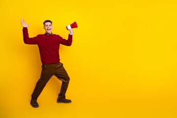 Happy Man With Megaphone On Yellow Background Expressing Excitement And Cheerful Gestures