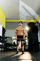 Bodybuilder lifting weights in a modern gym