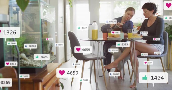 Two marketers pouring coffee at table in kitchen, displaying floating social media marketing icons