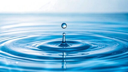 Pure Water Droplet Falling Creating Concentric Ripples on a Calm Blue Surface
