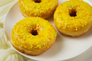 Yellow donuts on a white table. Sweet donuts