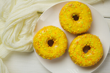 Yellow donuts on a pink background. Sweet donuts