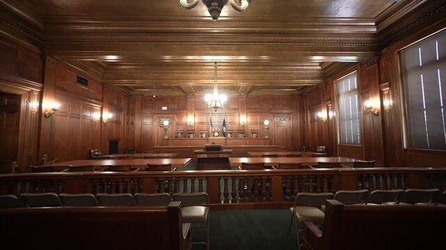 Wood-paneled walls highlight the interior of the Kentucky Supreme Court, showcasing its elegant design and seating arrangement for court proceedings in Frankfort.