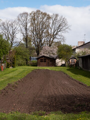 Rural Spring Garden with Freshly Plowed Soil © Svetlana