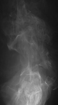 Abstract smoke texture over black background. Fog in the darkness.
