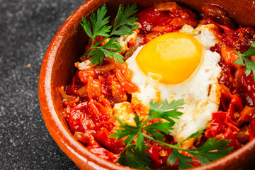Fried egg tomatoes shakshuka vegetable dish appetizer fresh delicious gourmet food background on the table rustic food top view copy space vegetarian  food