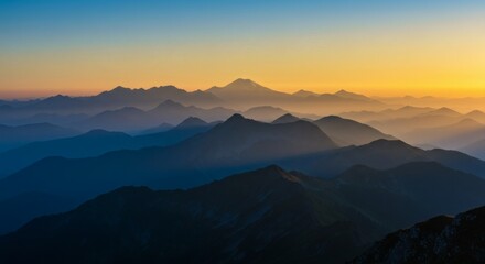 Obraz premium Spectacular mountain silhouettes at sunset, revealing layers of peaks against a colorful sky.