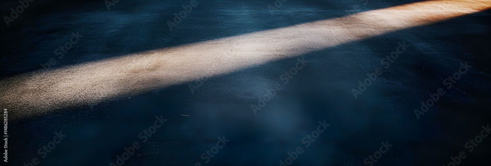 Poster abstract image of sunlight beam across a dark textured surface creating a dramatic atmospheric scene