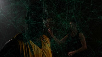 Two basketball teammates practicing sports tech in dark studio projecting green network around ball - Powered by Adobe