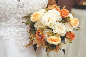 Wedding bouquet in bride's hands. Wedding background or decoration.